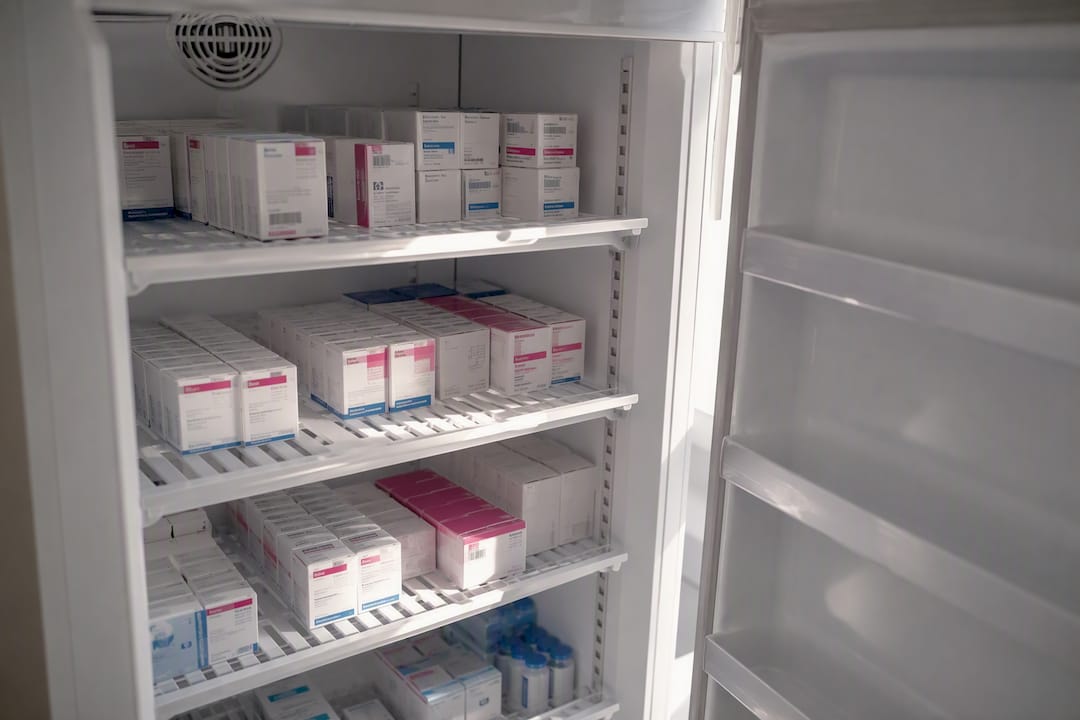 Neatly arranged medical fridge shelves with medicines