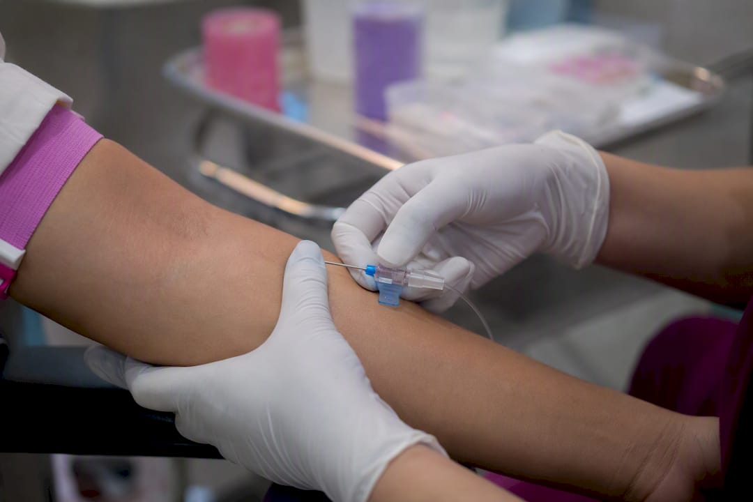 Hands inserting peripheral IV cannula