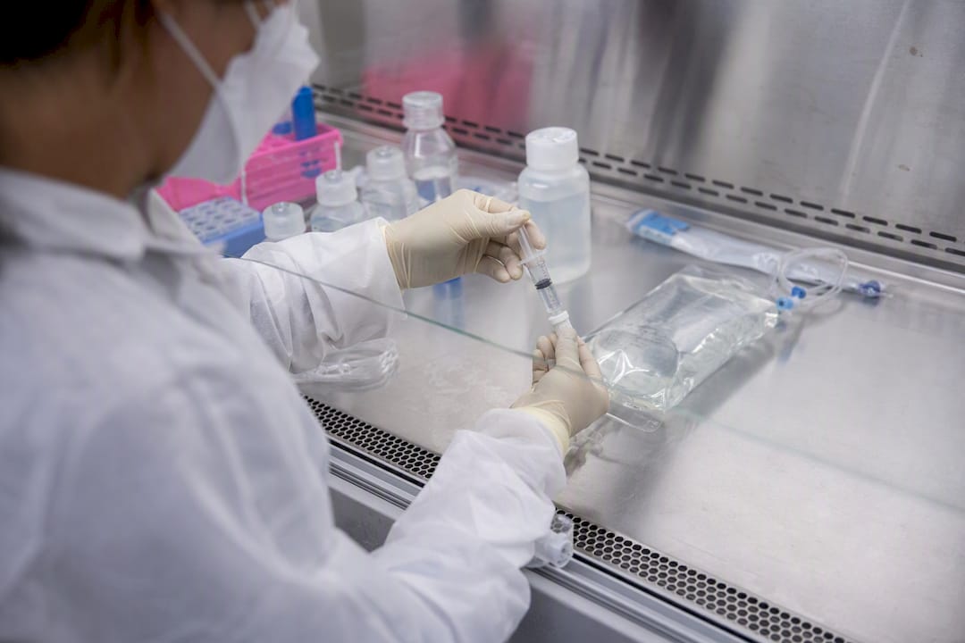 Hands compounding IV vitamin admixture under sterile conditions